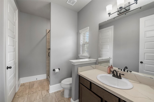 bathroom with vanity, walk in shower, and toilet