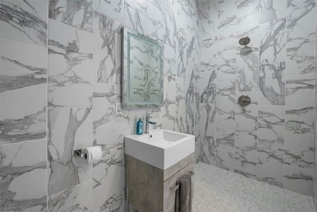 bathroom featuring sink and a tile shower