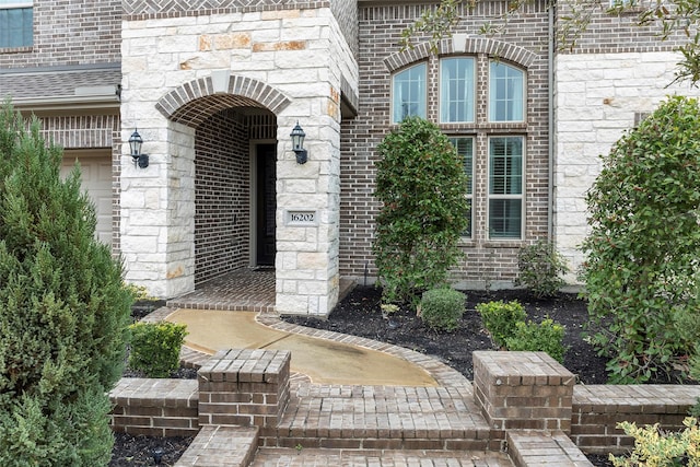 doorway to property with brick siding