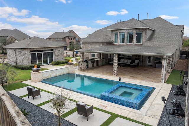 view of swimming pool featuring a patio area and an in ground hot tub