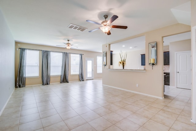 tiled spare room with ceiling fan