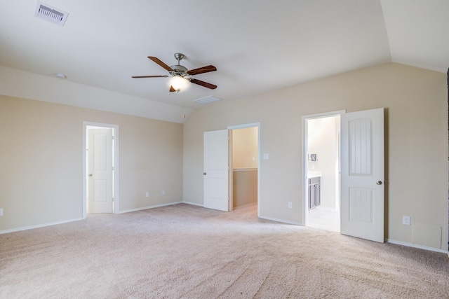 unfurnished room featuring vaulted ceiling, light colored carpet, and ceiling fan