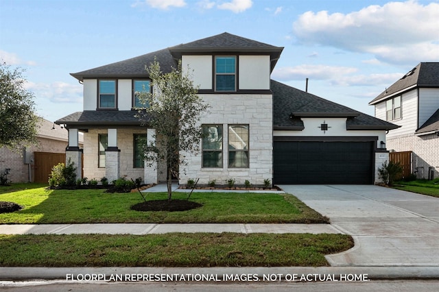 view of front facade with an attached garage, a shingled roof, driveway, stone siding, and a front yard