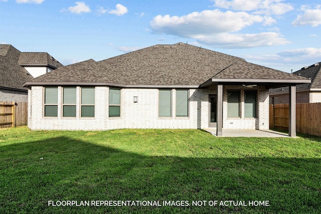 back of property featuring a shingled roof, a fenced backyard, a yard, a patio area, and brick siding