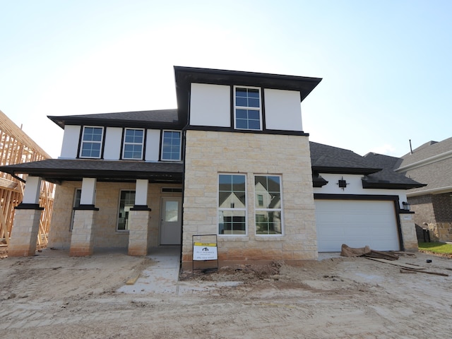 8411 Oceanmist Cove Dr, Cypress, TX 77433 - view of front facade with stone siding, a garage, and roof with shingles