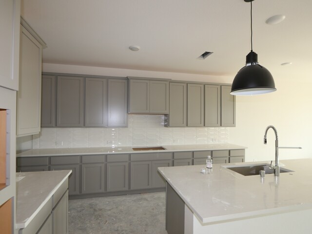 8411 Oceanmist Cove Dr, Cypress, TX 77433 - kitchen featuring gray cabinetry, a sink, backsplash, and decorative light fixtures