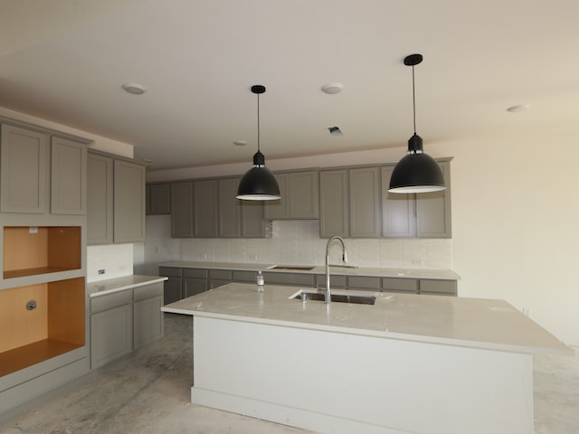 8411 Oceanmist Cove Dr, Cypress, TX 77433 - kitchen featuring gray cabinets, a sink, and a kitchen island with sink