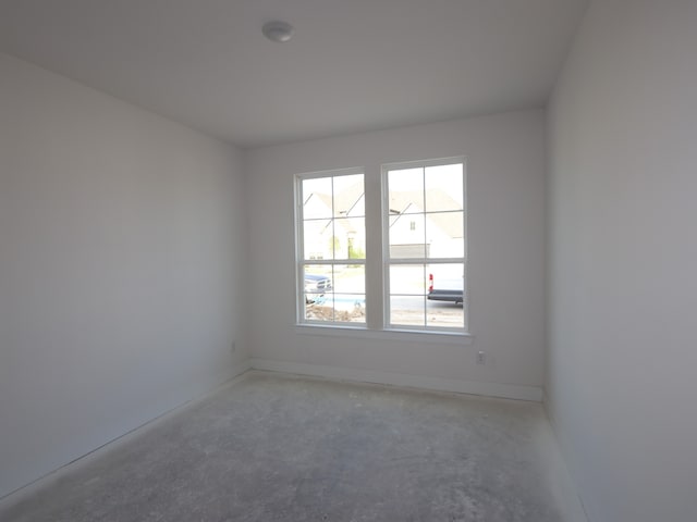 8411 Oceanmist Cove Dr, Cypress, TX 77433 - empty room with plenty of natural light, concrete flooring, and baseboards