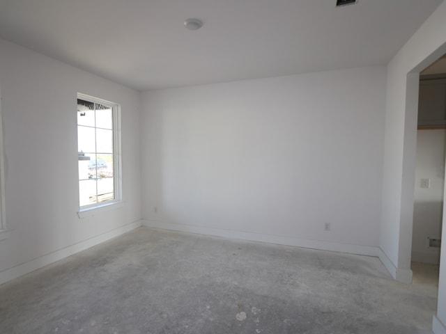 8411 Oceanmist Cove Dr, Cypress, TX 77433 - empty room with unfinished concrete flooring and baseboards