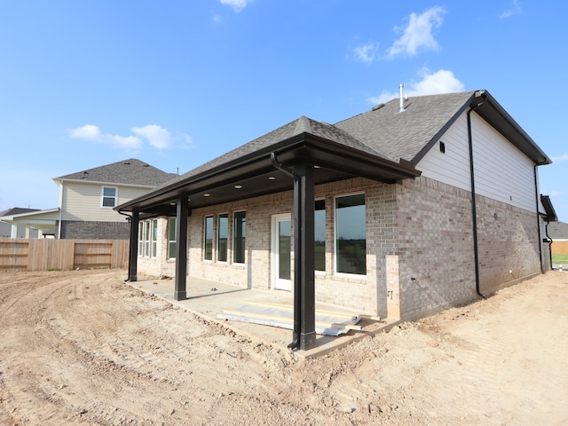 8411 Oceanmist Cove Dr, Cypress, TX 77433 - rear view of house with brick siding, a patio area, and a shingled roof