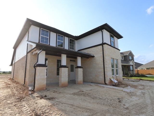 8411 Oceanmist Cove Dr, Cypress, TX 77433 - back of property with stone siding and covered porch