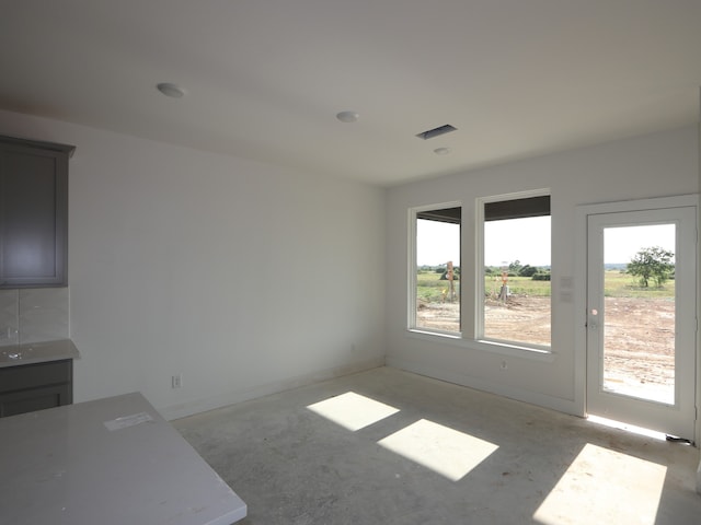 8411 Oceanmist Cove Dr, Cypress, TX 77433 - unfurnished dining area with plenty of natural light, concrete flooring, and baseboards