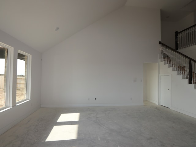 8411 Oceanmist Cove Dr, Cypress, TX 77433 - unfurnished living room with stairs, high vaulted ceiling, unfinished concrete flooring, and baseboards