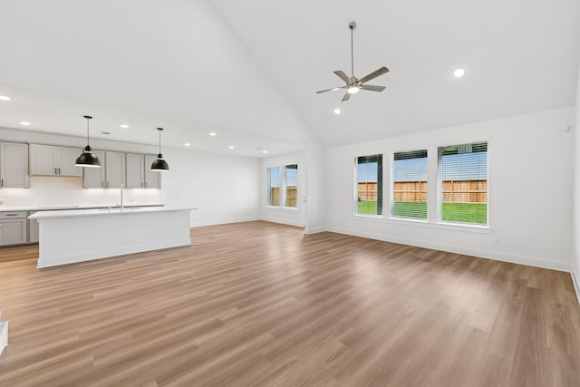 8411 Oceanmist Cove Dr, Cypress, TX 77433 - unfurnished living room featuring recessed lighting, ceiling fan, high vaulted ceiling, and light wood-style flooring