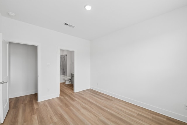 8411 Oceanmist Cove Dr, Cypress, TX 77433 - unfurnished bedroom featuring light wood finished floors and connected bathroom