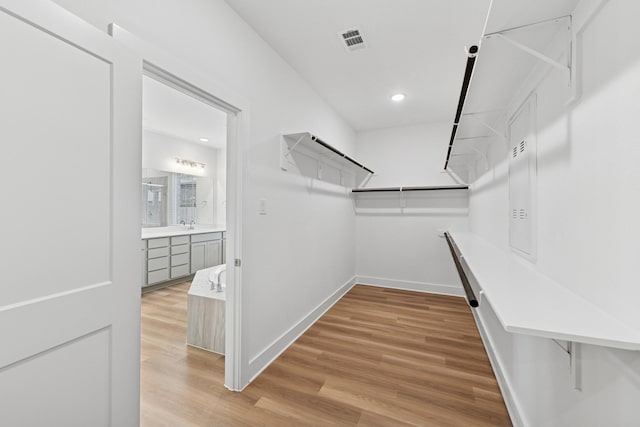 8411 Oceanmist Cove Dr, Cypress, TX 77433 - walk in closet with wood finished floors