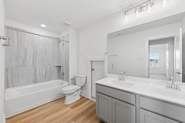 8411 Oceanmist Cove Dr, Cypress, TX 77433 - bathroom with double vanity, shower / bath combination, wood finished floors, and recessed lighting