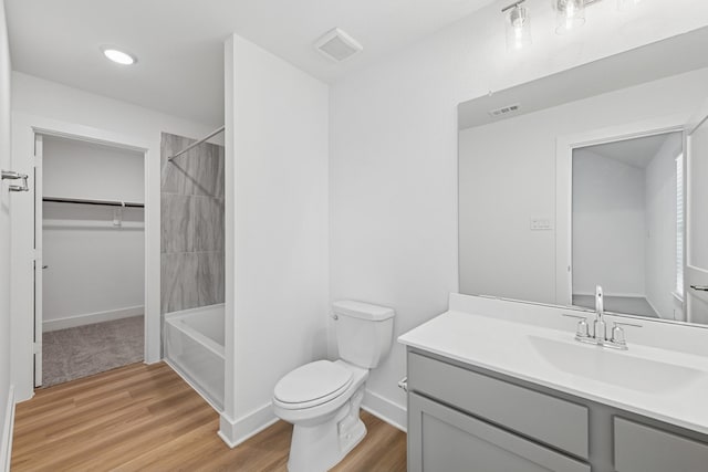 8411 Oceanmist Cove Dr, Cypress, TX 77433 - bathroom featuring vanity, wood finished floors, bathing tub / shower combination, and a spacious closet