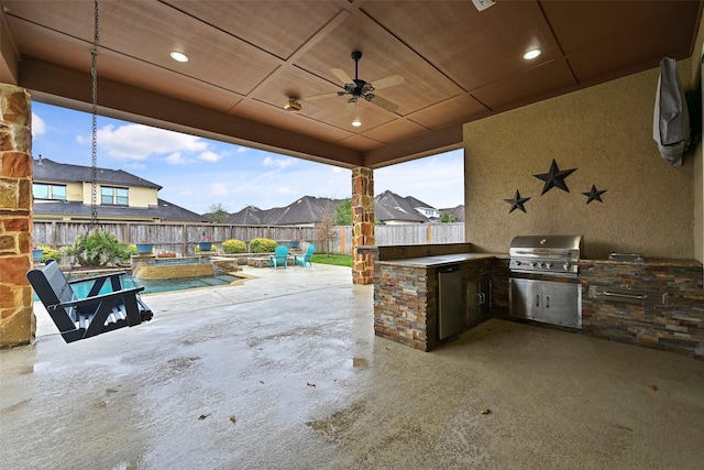 view of patio / terrace featuring exterior kitchen, a fenced in pool, and grilling area