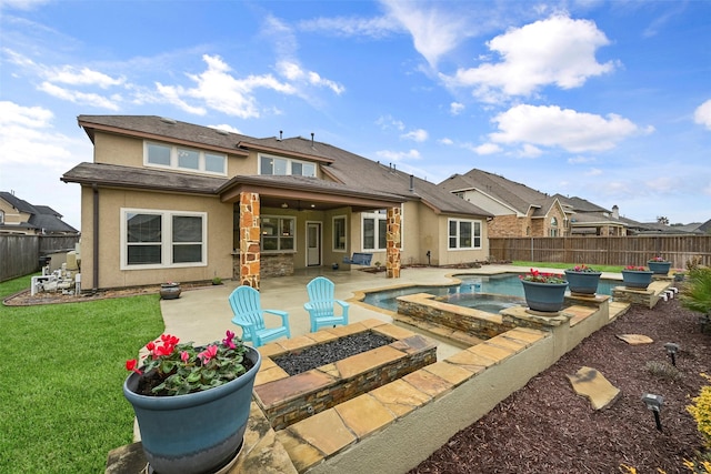 rear view of property with a yard, a fenced in pool, and a patio area