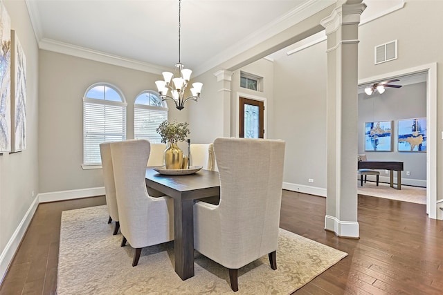 dining space with ornate columns, ornamental molding, dark wood-type flooring, and a notable chandelier