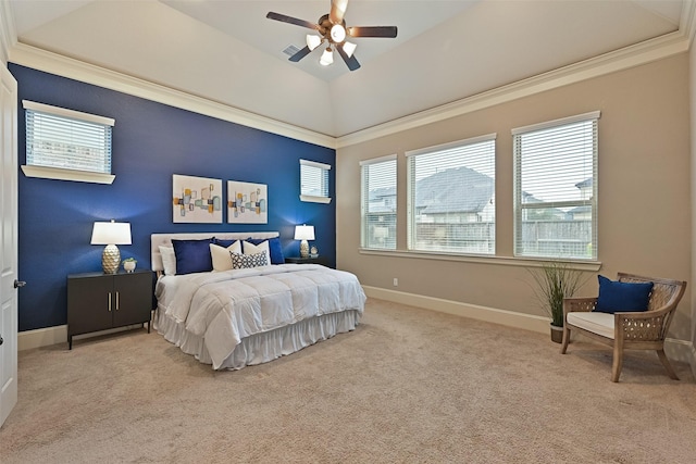 bedroom featuring a raised ceiling, vaulted ceiling, light colored carpet, and ceiling fan