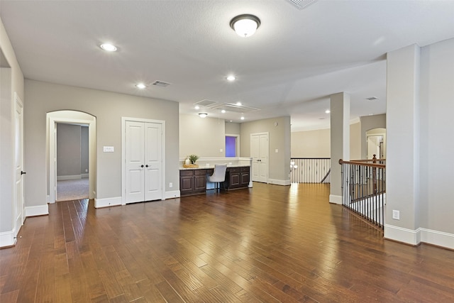 unfurnished living room with dark hardwood / wood-style floors