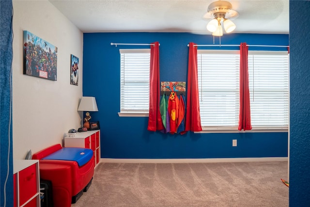 playroom with ceiling fan and carpet floors