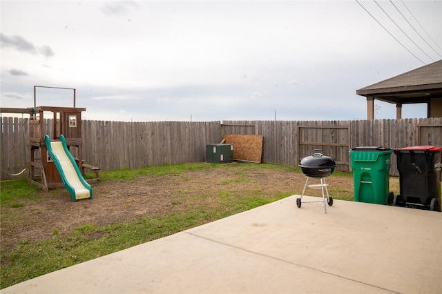 view of patio / terrace with area for grilling and a playground