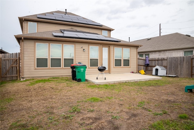 rear view of house featuring a yard and a patio