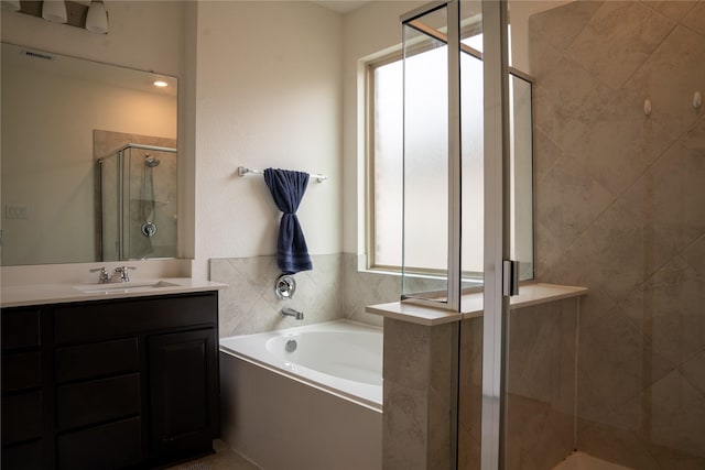 bathroom with independent shower and bath and vanity