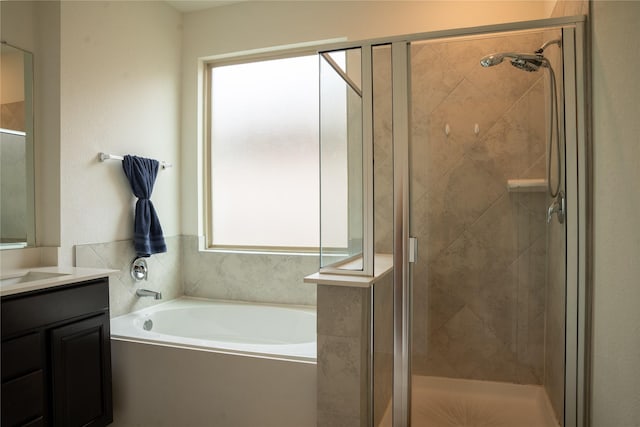 bathroom featuring vanity and separate shower and tub