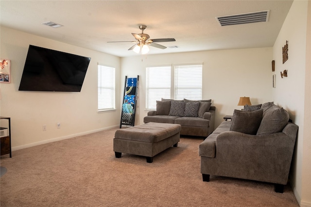 carpeted living room featuring ceiling fan