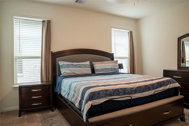 carpeted bedroom featuring multiple windows