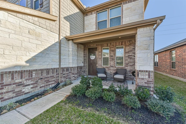 entrance to property featuring brick siding