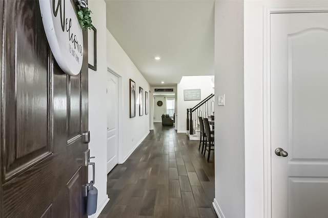 foyer entrance with dark wood-style floors, baseboards, stairway, and recessed lighting