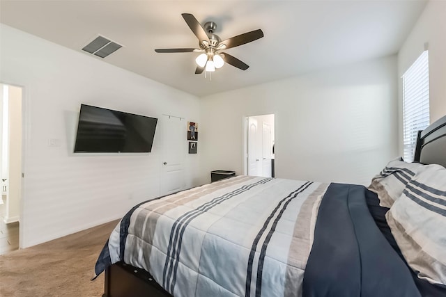 carpeted bedroom featuring visible vents and a ceiling fan