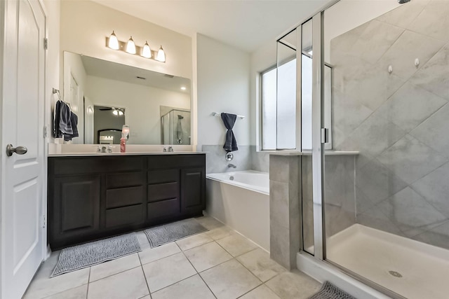 bathroom with a sink, a shower stall, a bath, tile patterned floors, and double vanity