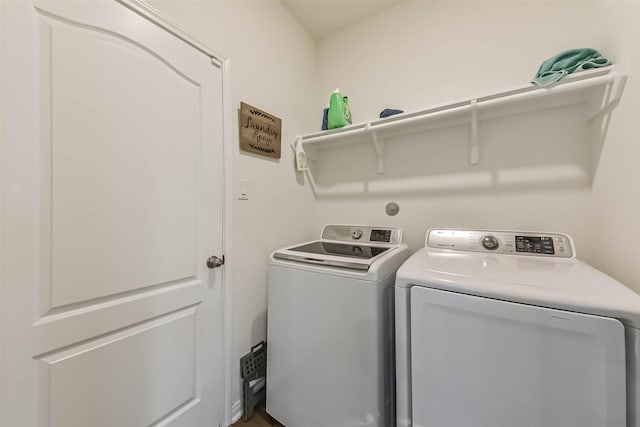 clothes washing area featuring washing machine and dryer and laundry area