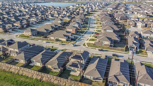 birds eye view of property with a water view and a residential view