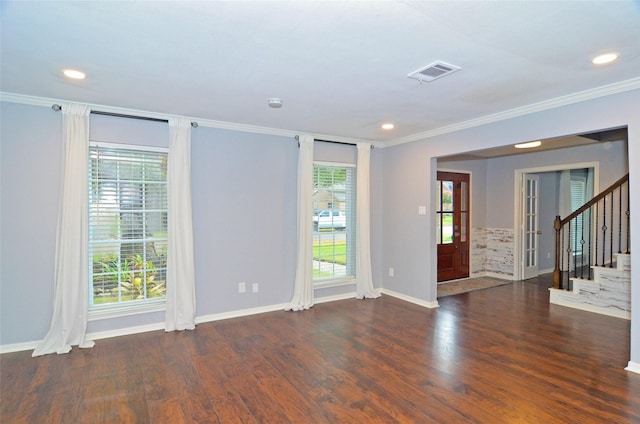 empty room with stairs, dark wood-style flooring, visible vents, and a healthy amount of sunlight