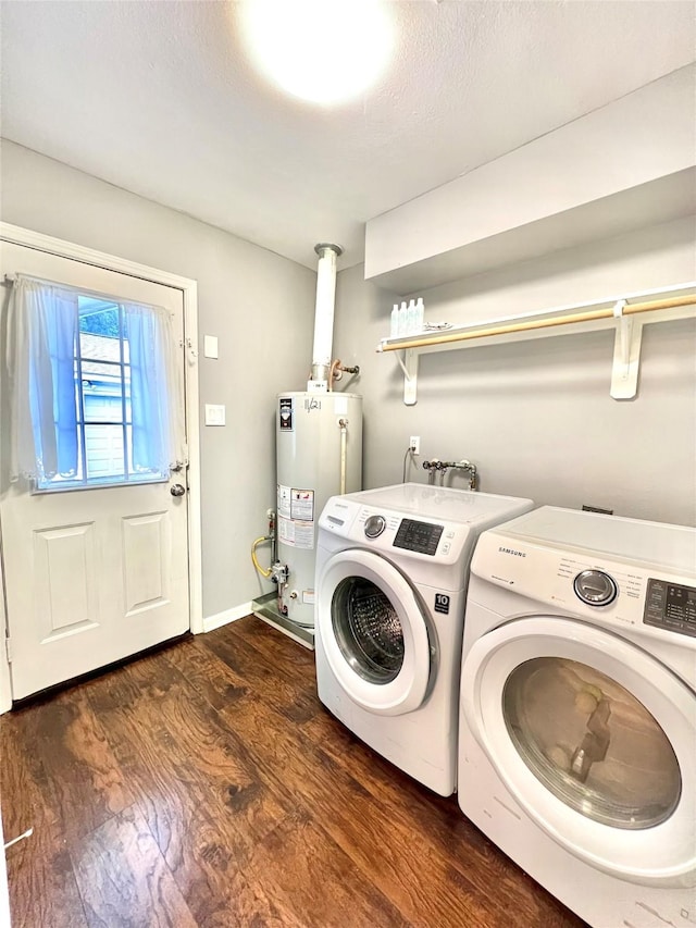 washroom with laundry area, dark wood-type flooring, baseboards, water heater, and independent washer and dryer