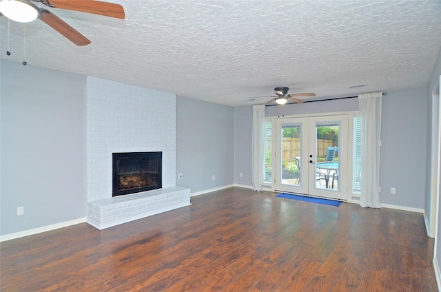 unfurnished living room featuring french doors, dark wood-style flooring, a fireplace, and baseboards