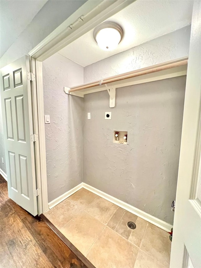 laundry room with a textured wall, washer hookup, and electric dryer hookup