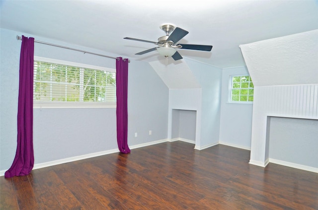 additional living space featuring dark wood-style floors, baseboards, and vaulted ceiling