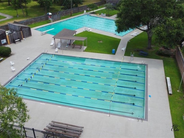 community pool with a lawn, a patio, fence, a gazebo, and a diving board