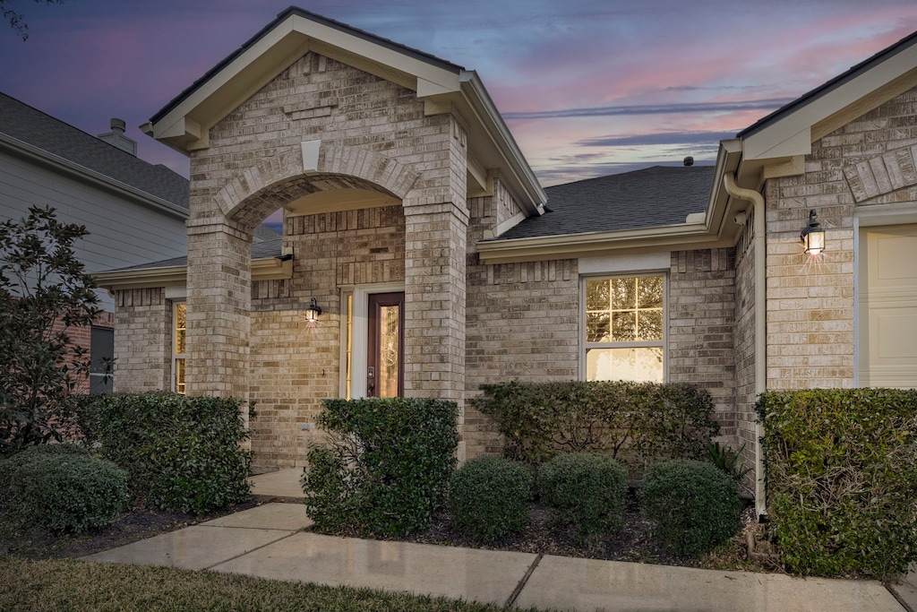 view of exterior entry at dusk