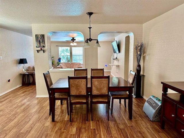 dining area featuring hardwood / wood-style floors and a textured ceiling