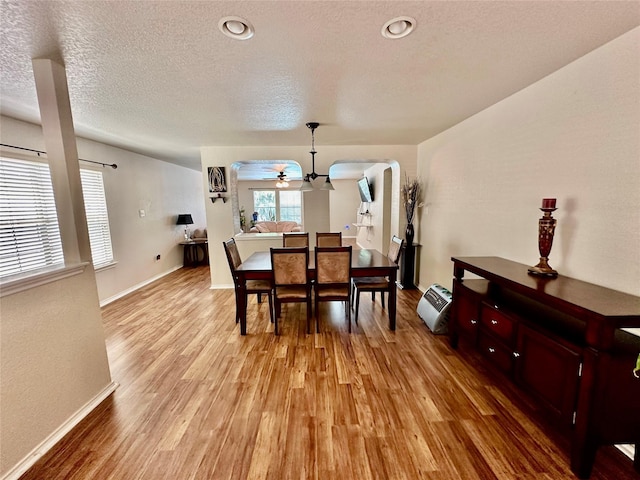 dining area featuring ceiling fan, a textured ceiling, and light hardwood / wood-style floors