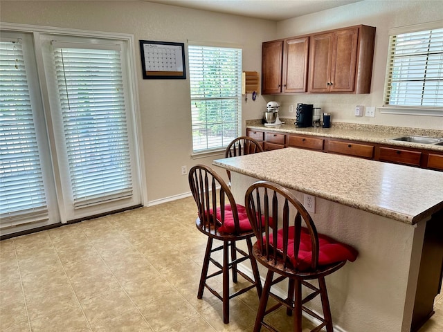 kitchen with a kitchen island, sink, and a breakfast bar area